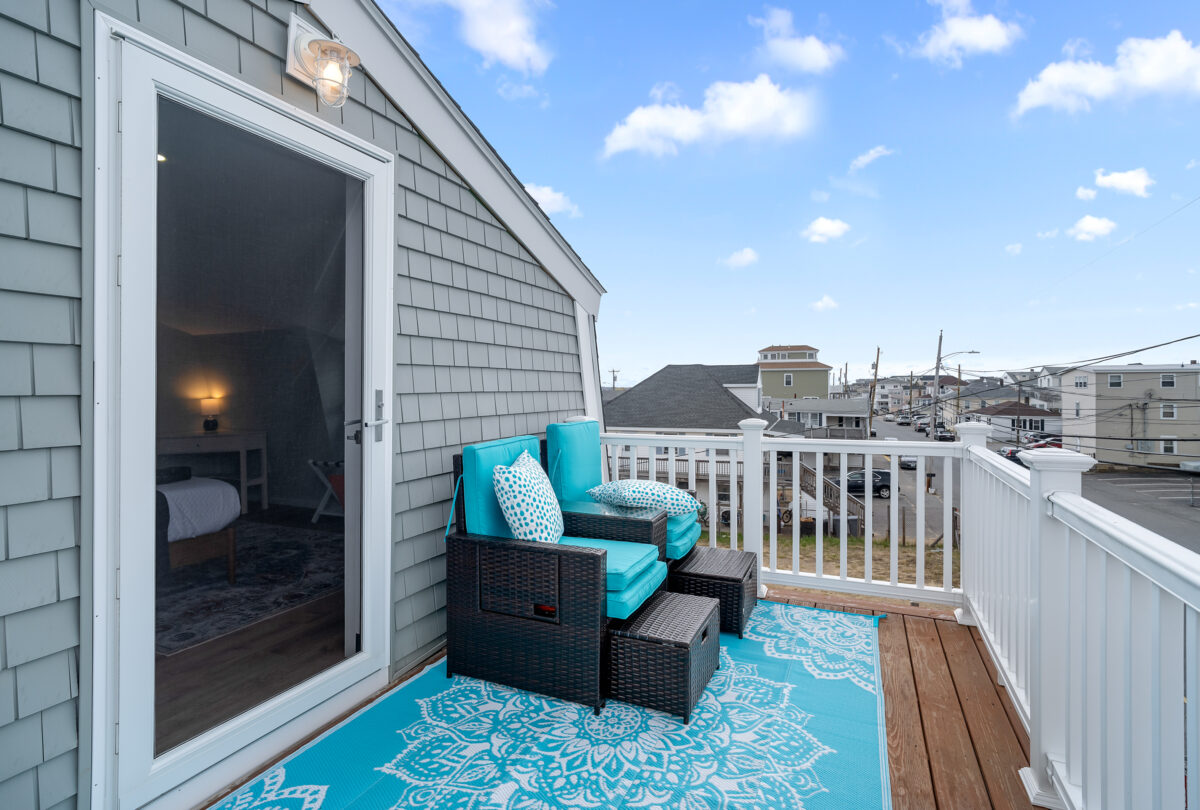 Shingled deck with turquoise seating and rooftop views