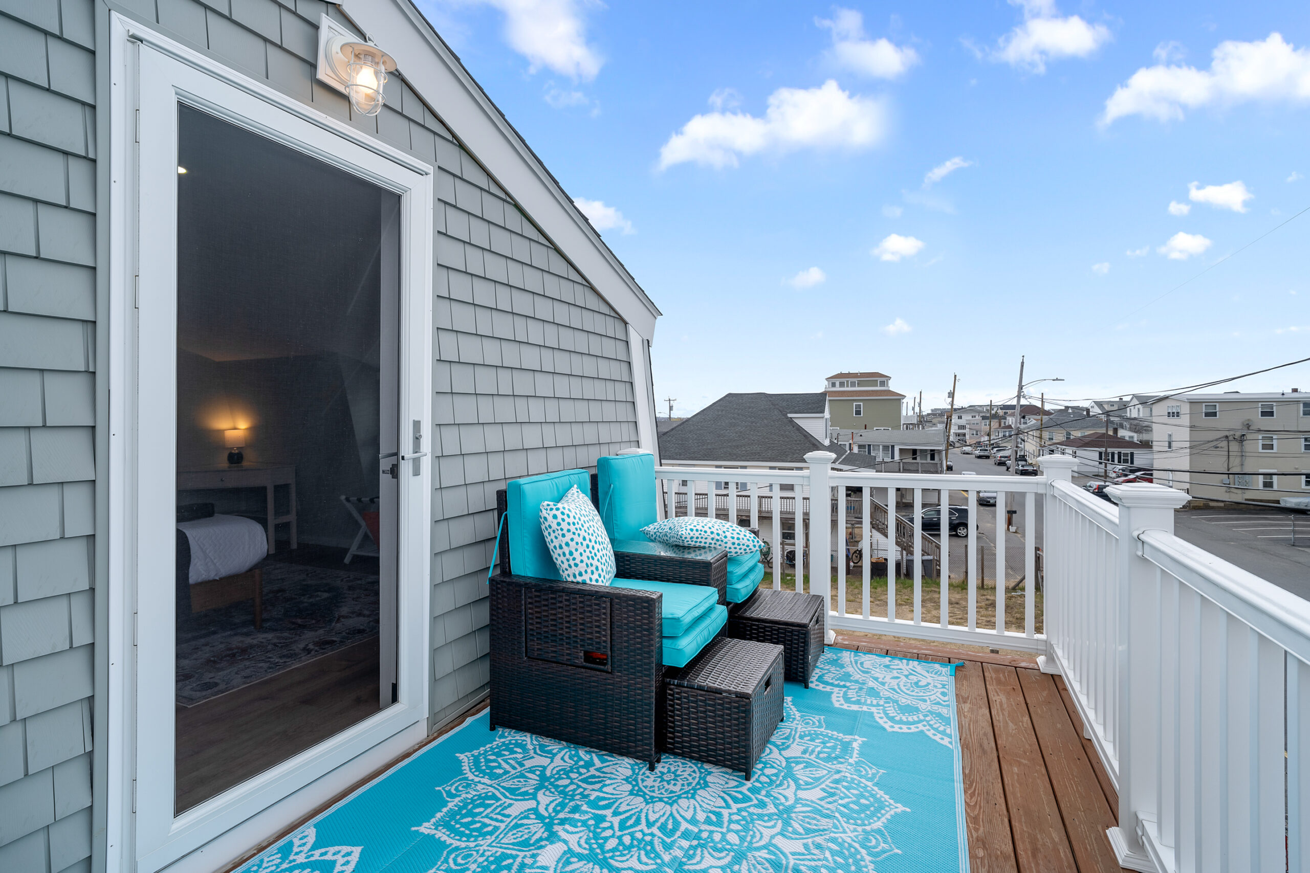 Shingled deck with turquoise seating and rooftop views