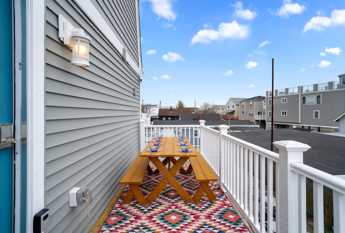 Rooftop deck with a picnic table on a kilim-patterned rug