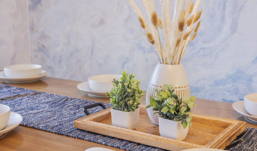 Dried pampas in a ceramic vase on a styled wooden tray