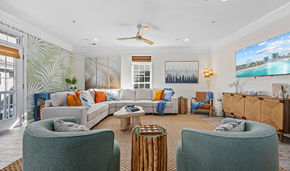 Living room with a cream sectional sofa and teal armchairs