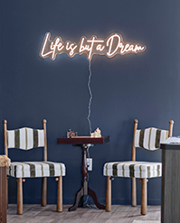 Navy bar area with a neon Life is but a Dream sign