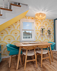 Breakfast nook with yellow scallop-patterned wallpaper