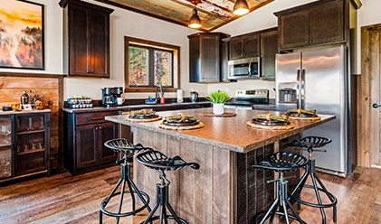 Kitchen with dark timber cabinets and a reclaimed wood island