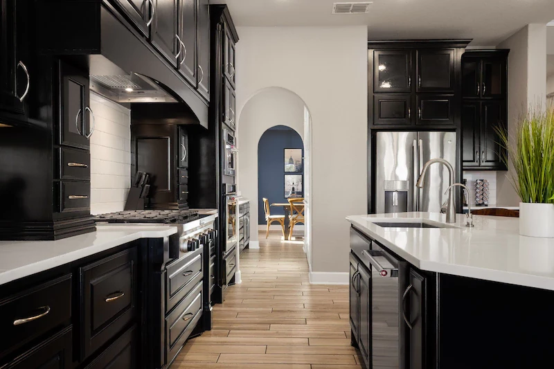 Dark timber kitchen with a marble island and an arched doorway
