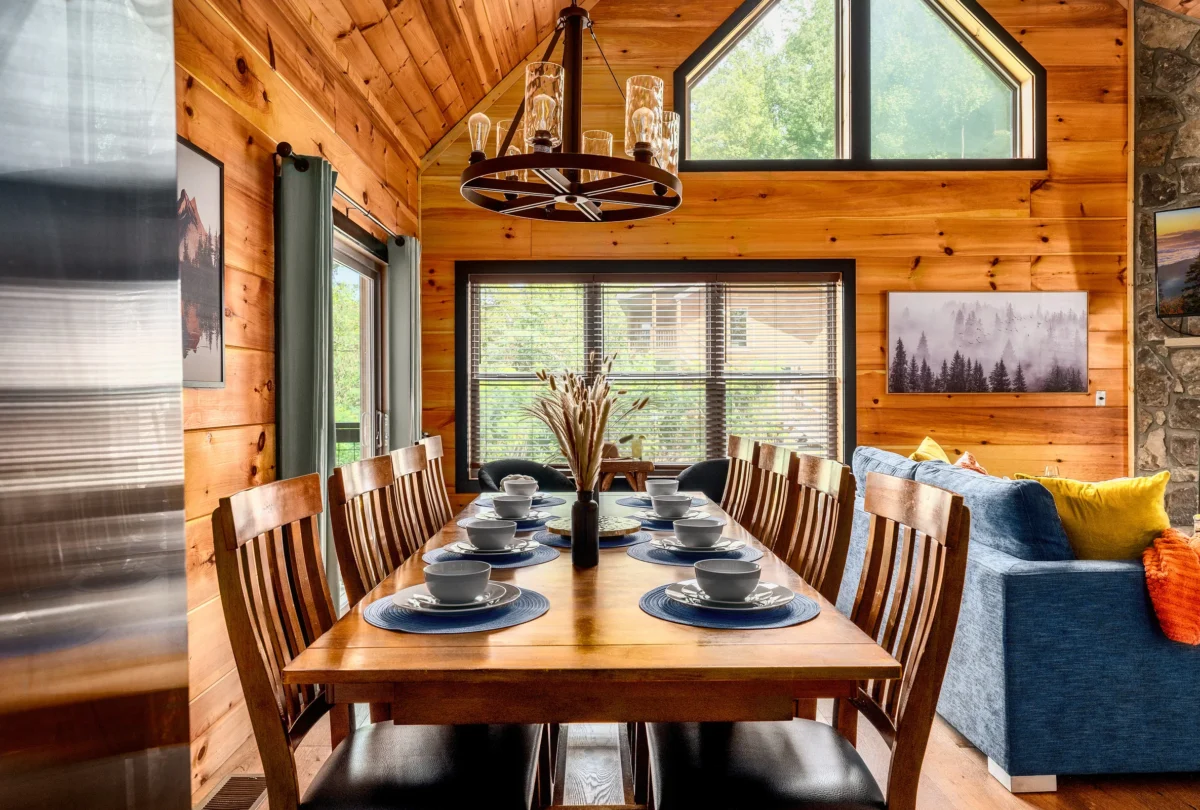 Dining table set for eight beneath an antler chandelier