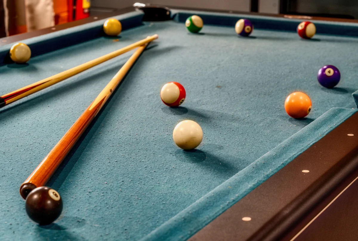 Pool table with cues and balls racked up