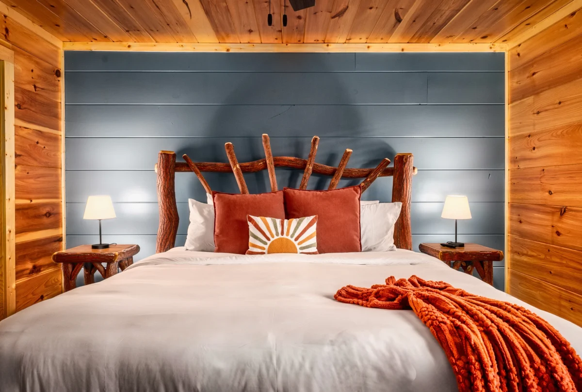 Bedroom with a blue panelled accent wall behind the bed