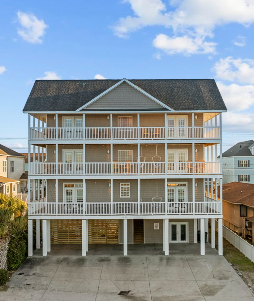 Four-storey shingled beach house with white balconies