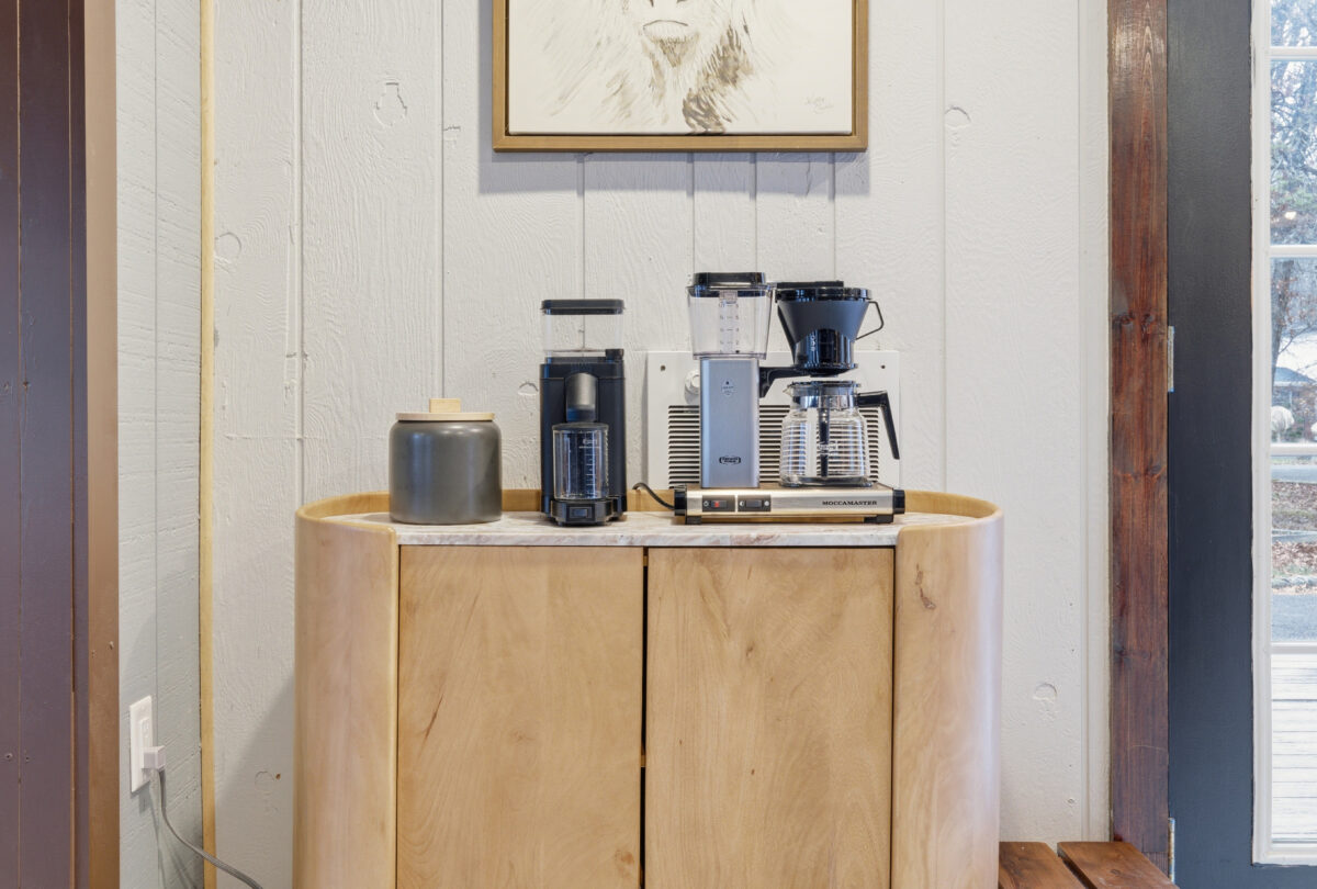 Coffee station with a filter machine on a curved wood cabinet