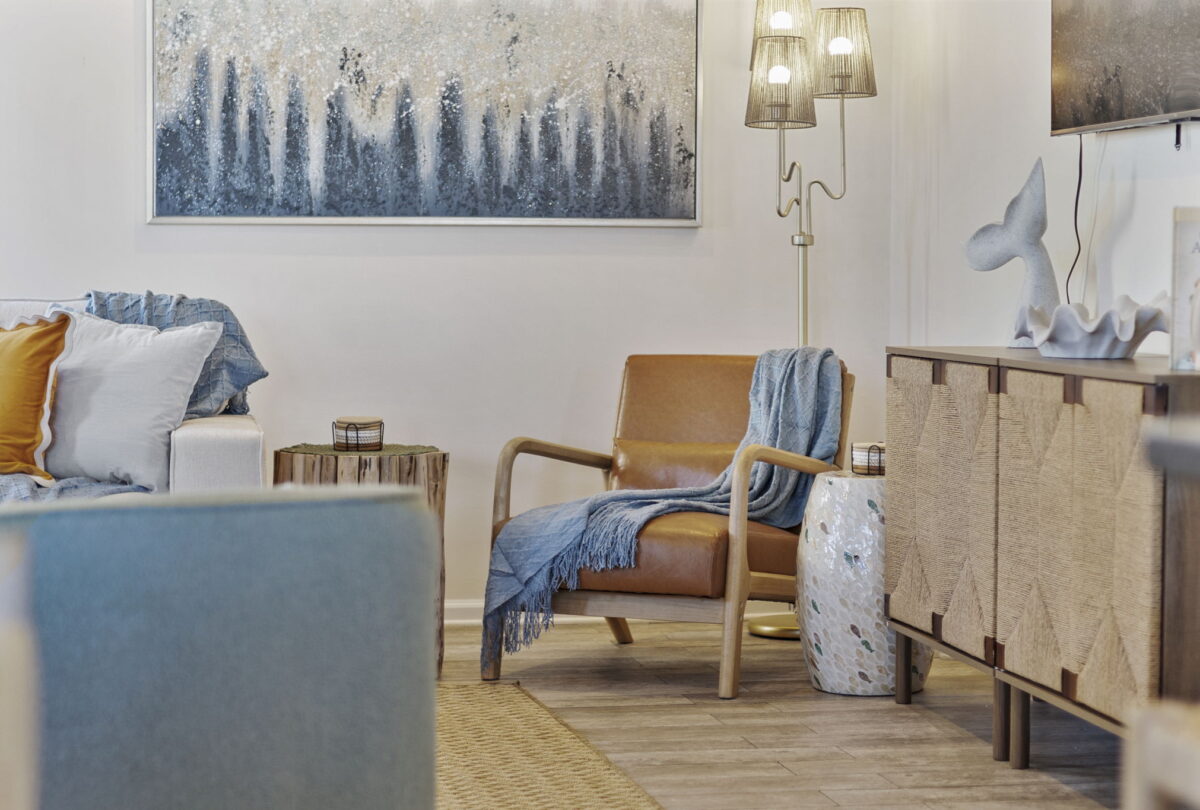 Reading corner with a leather armchair and a forest painting