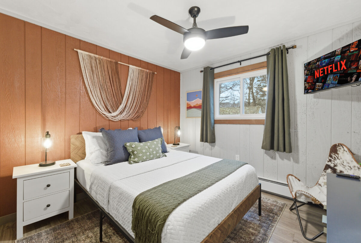 Bedroom with timber panelling and a macrame headboard