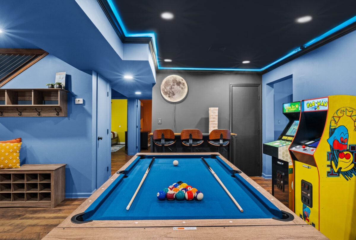 Basement games room with a pool table and blue LED ceiling lighting