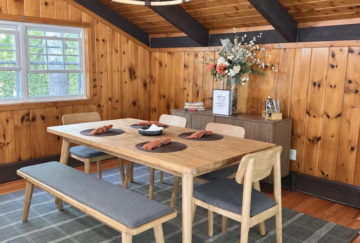 Dining table set beneath an iron chandelier