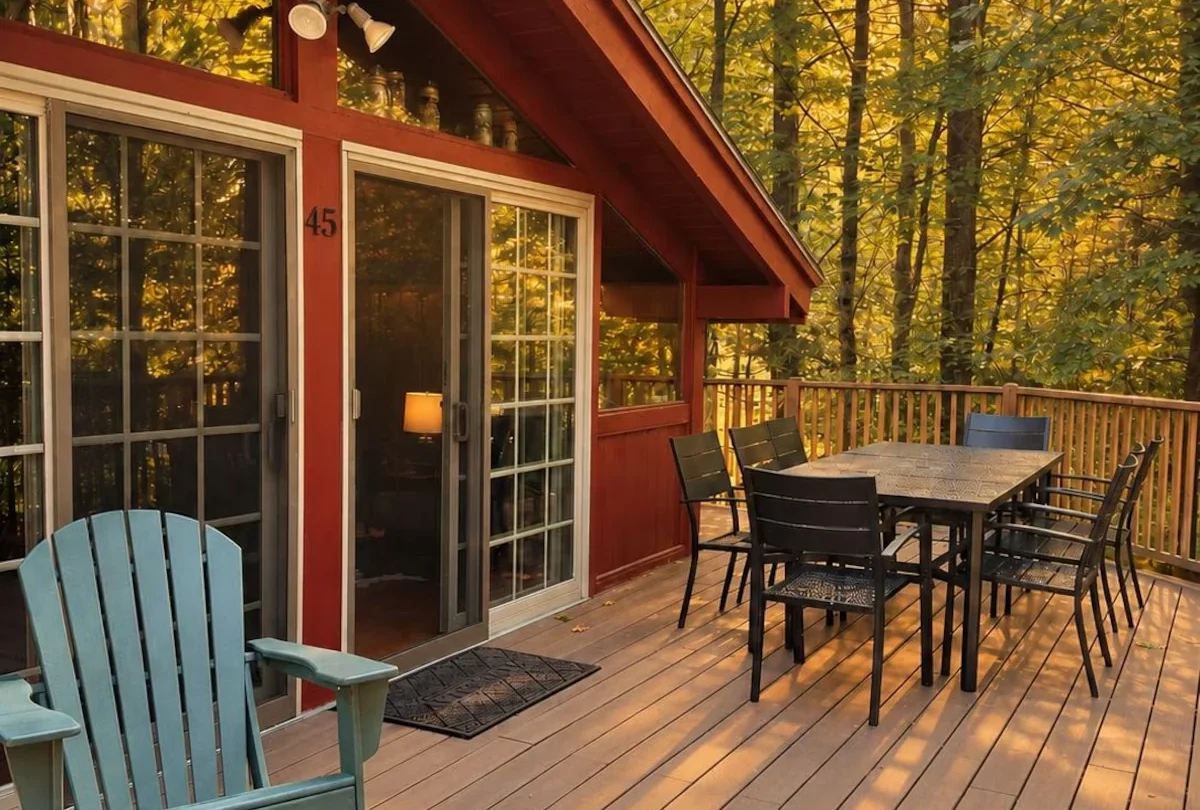 Covered deck with a rocking chair and dining table