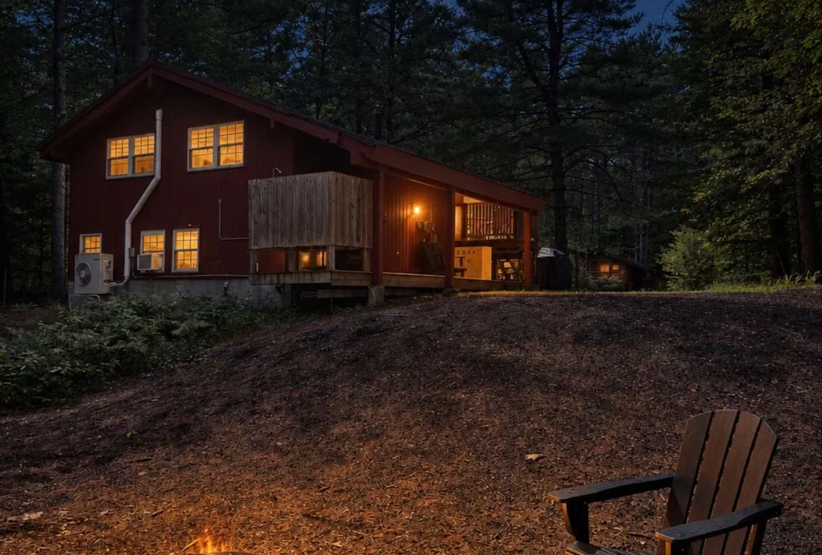 The fire pit lit among the pines after dark