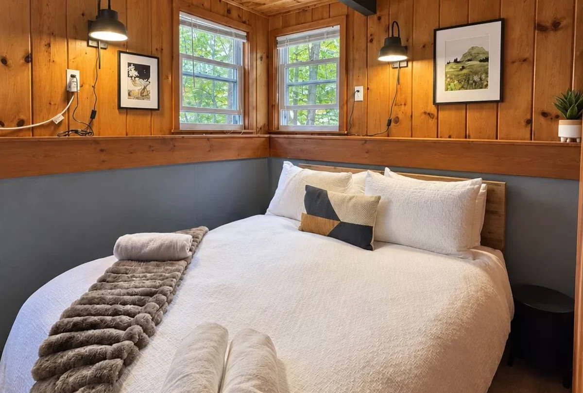 Bedroom with a knitted throw and framed prints
