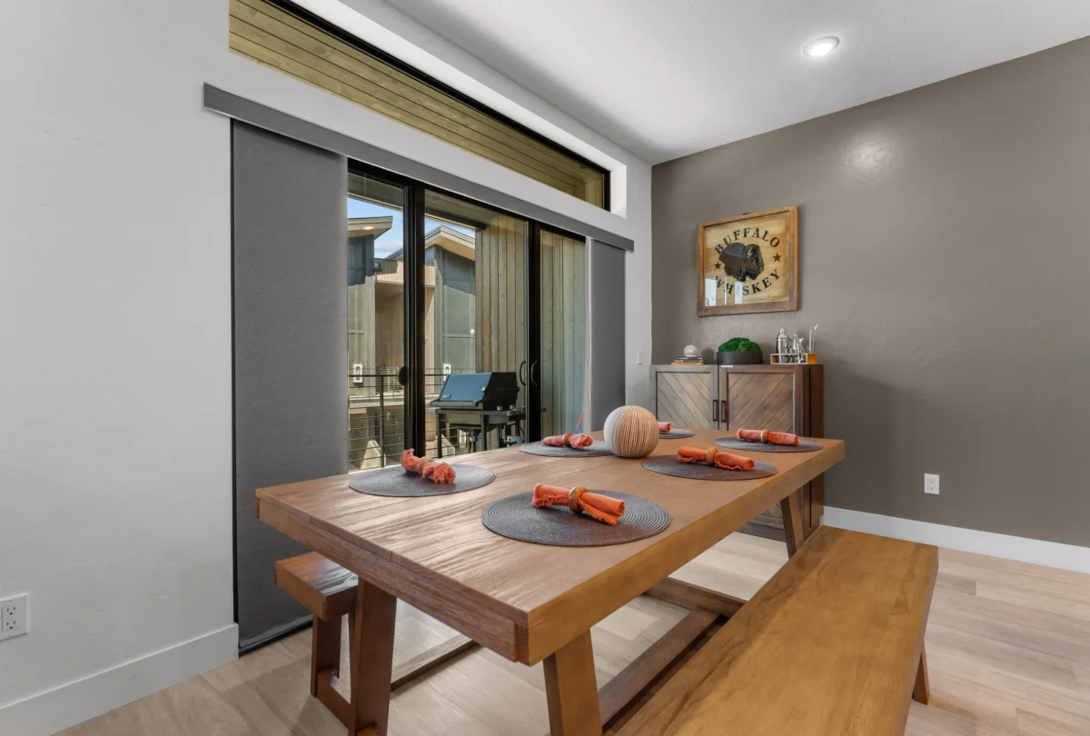 Timber dining table with benches beside the window