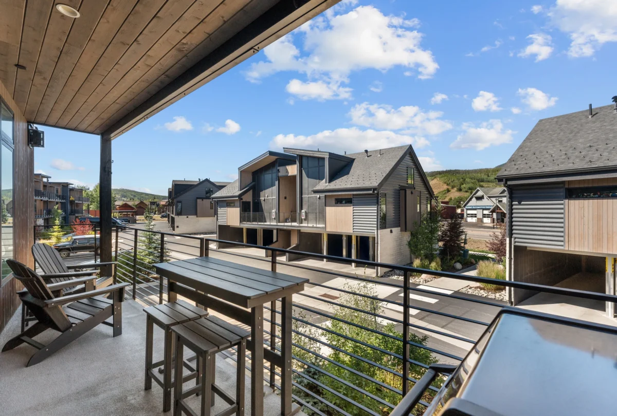 Deck with chairs and a cable railing above the valley