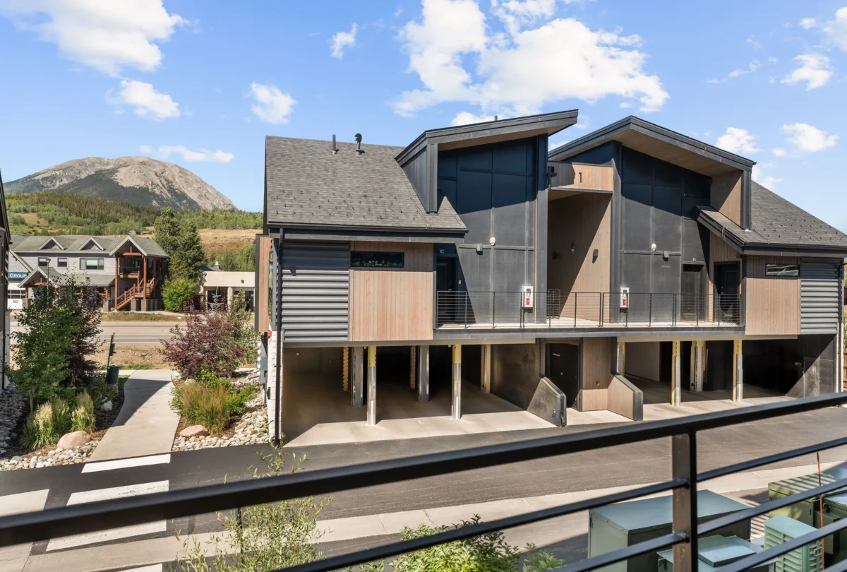 The condo building with the mountain behind it