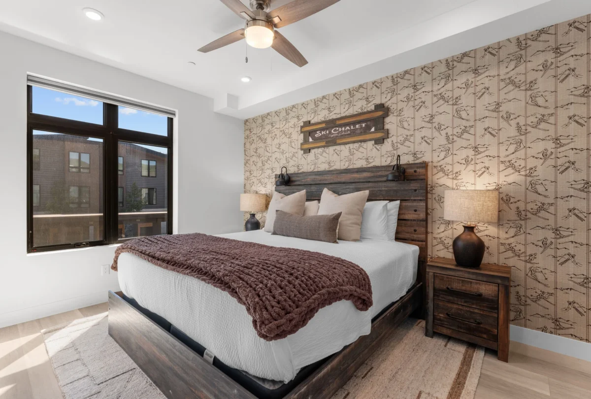 Bedroom with a timber headboard and a brown knitted throw