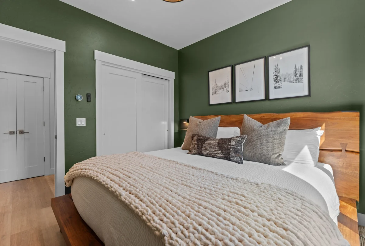 Second green bedroom with a chunky knitted throw