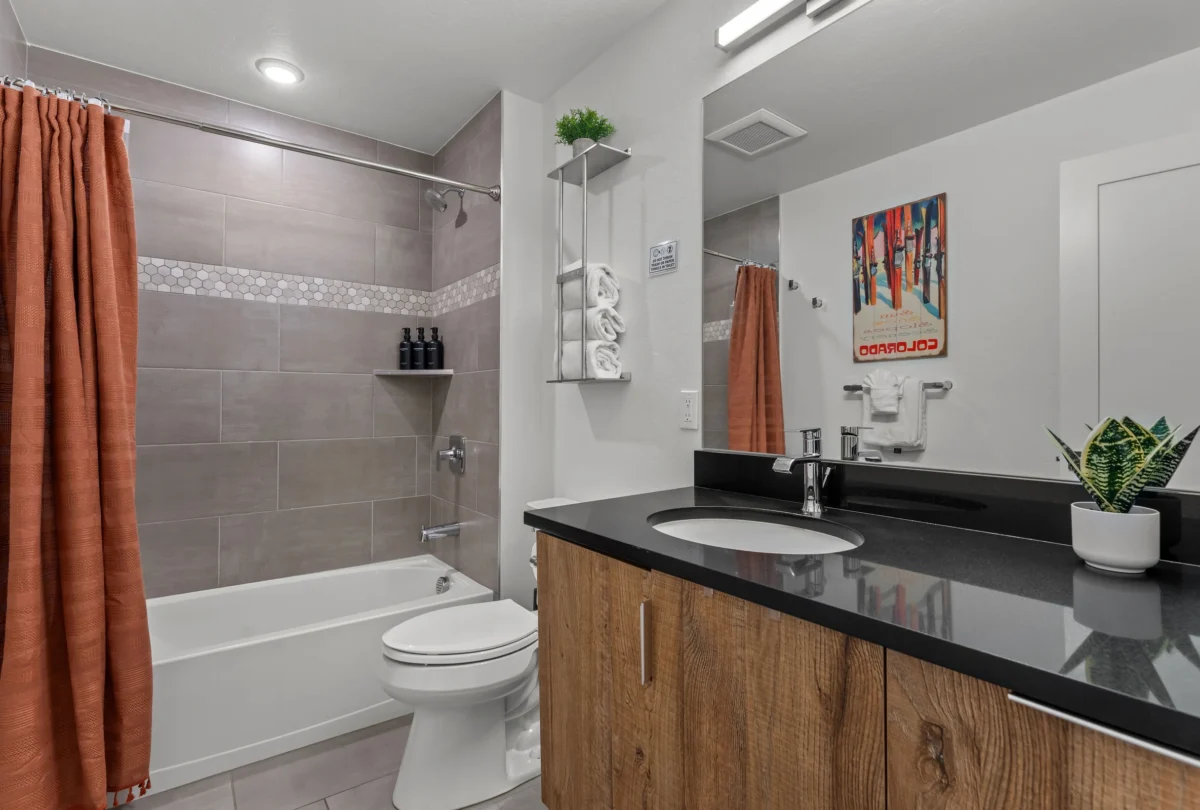 Bathroom with a bath and herringbone tiling