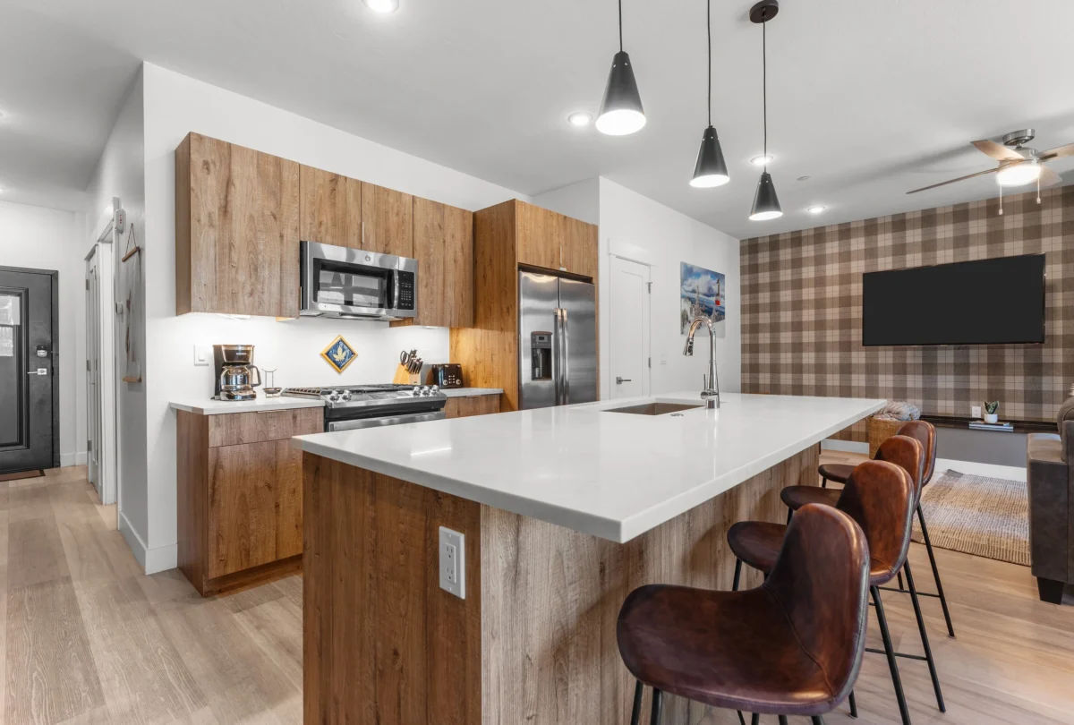 Kitchen with a white island and tan leather stools