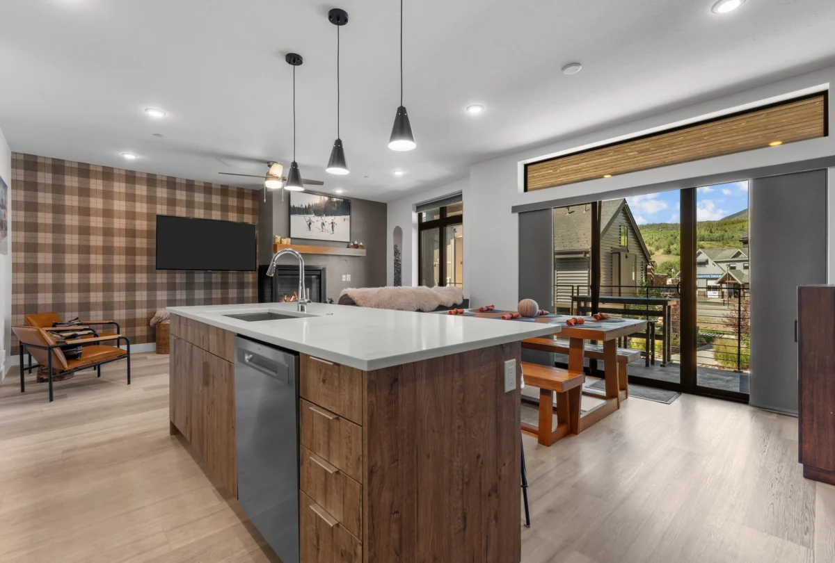 Open-plan kitchen and living room with a plaid feature wall