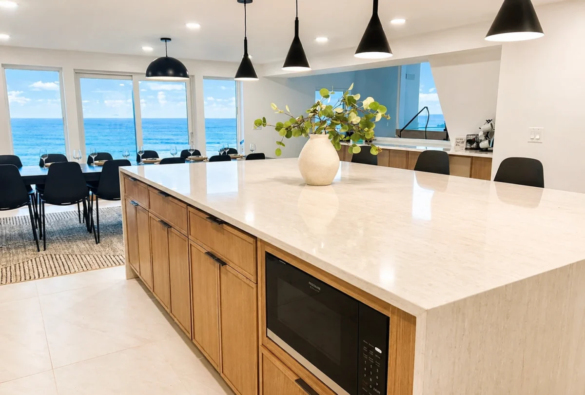 Kitchen with a marble island and black pendant lights