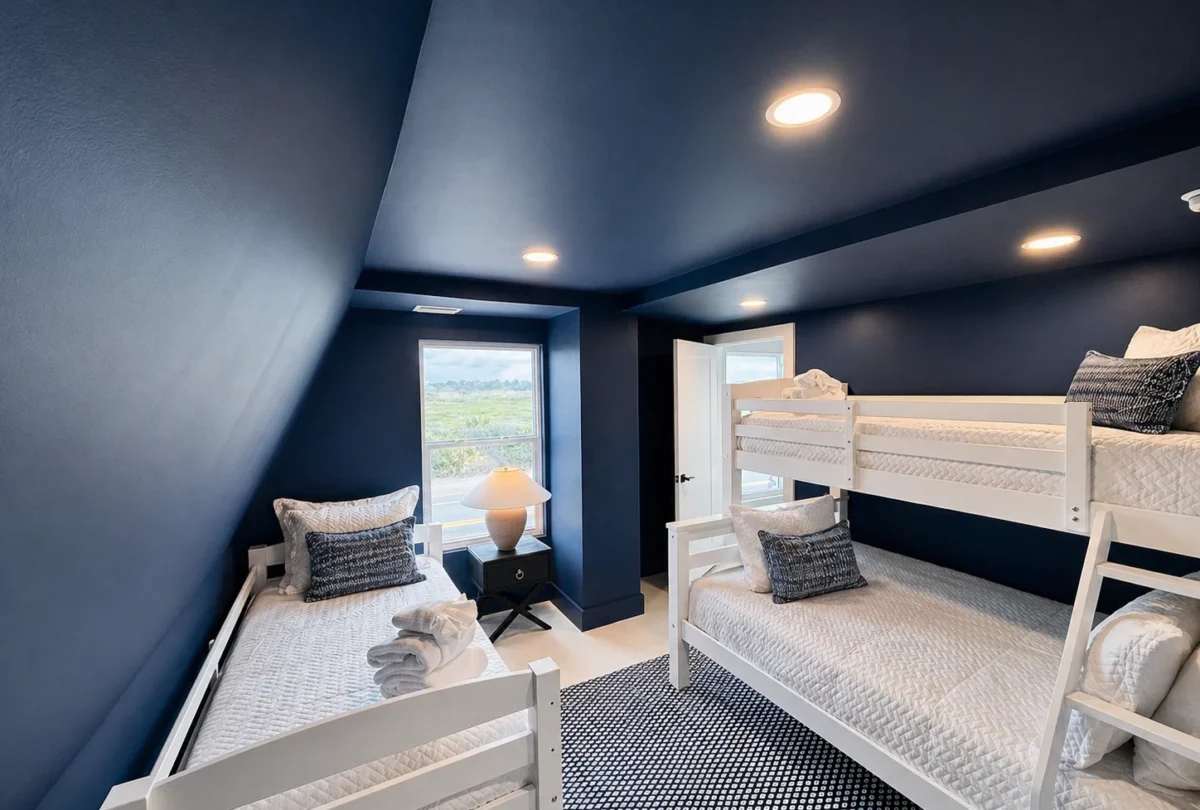 Bunk room with navy blue walls and a ladder