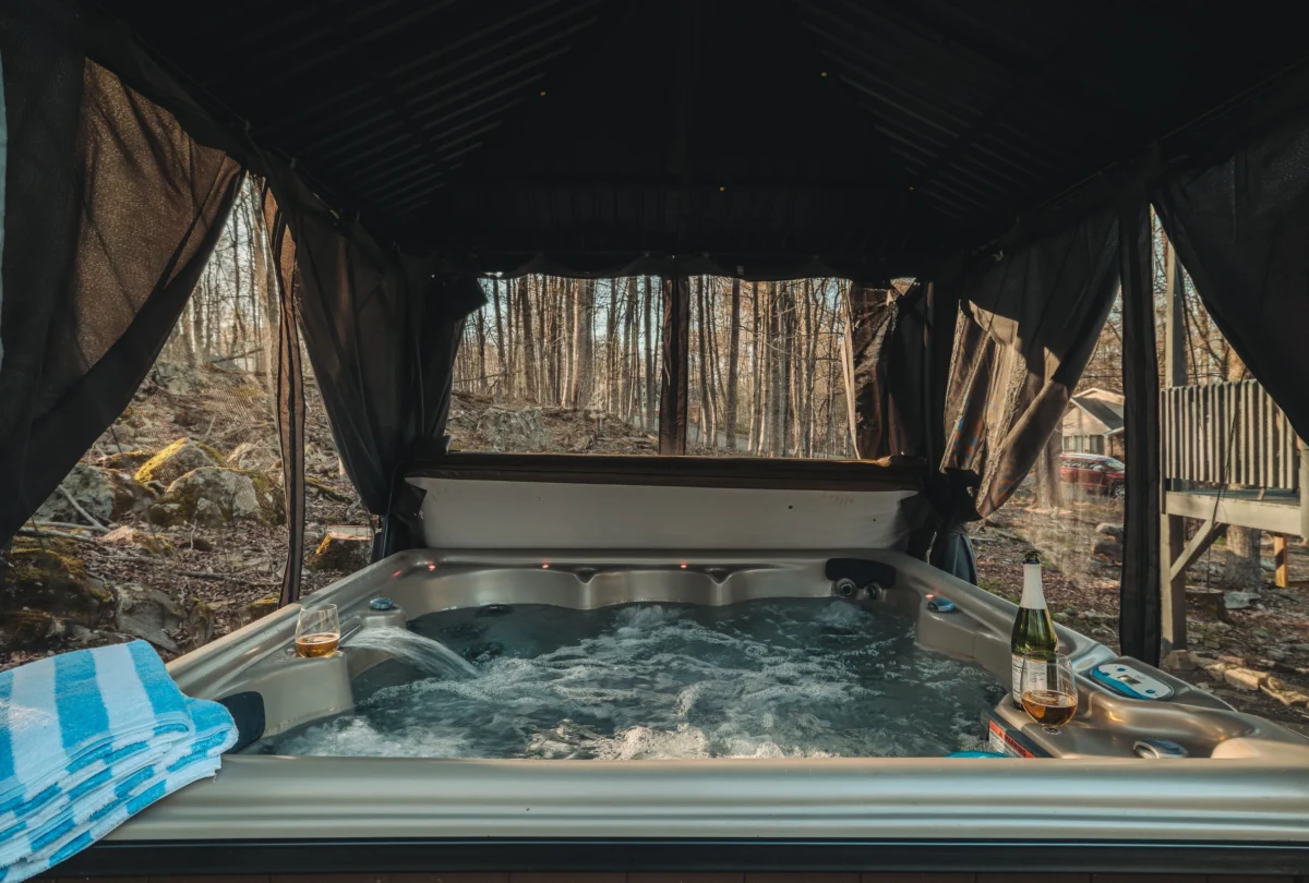 Hot tub under a covered pergola on the deck