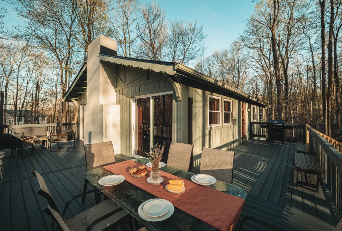 Deck dining table set at sunset beside the cabin