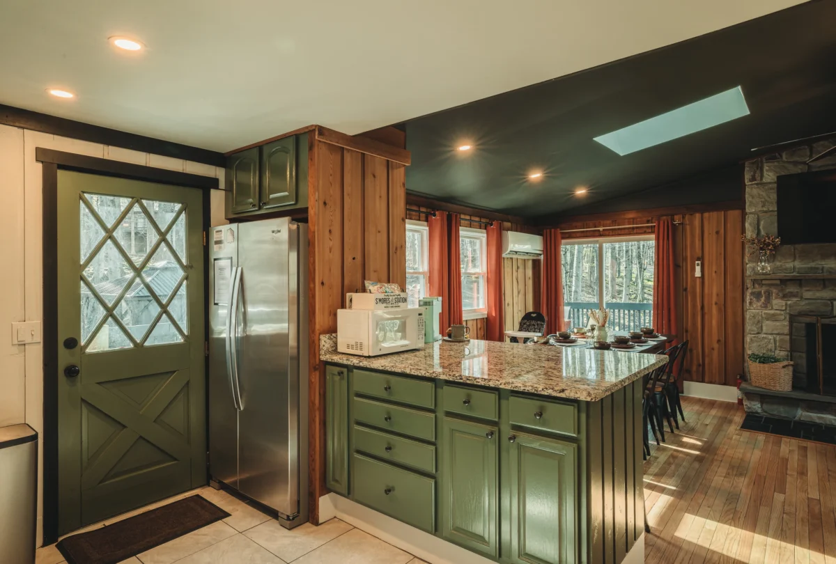 Kitchen with green cabinets and a glazed barn door