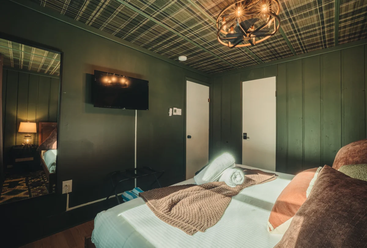 Bedroom with a pressed tin ceiling and dark green walls