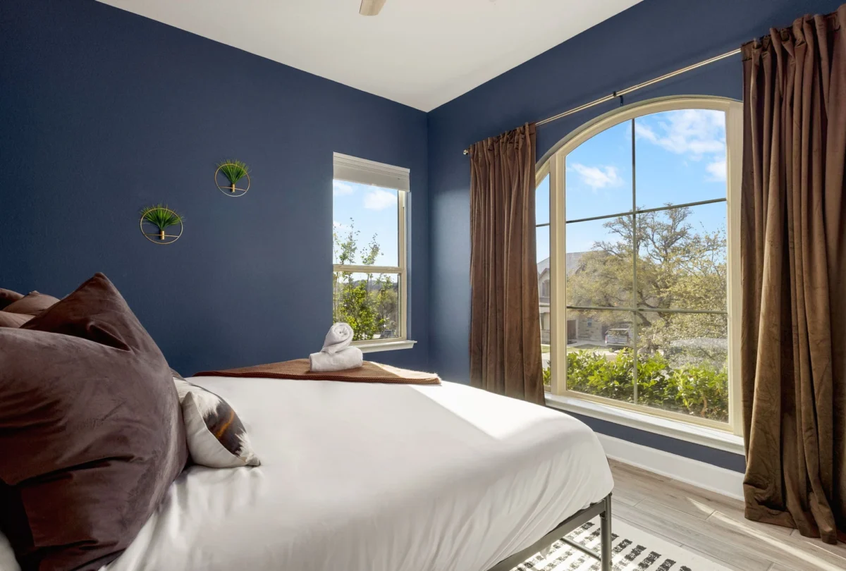 Navy bedroom with an arched window