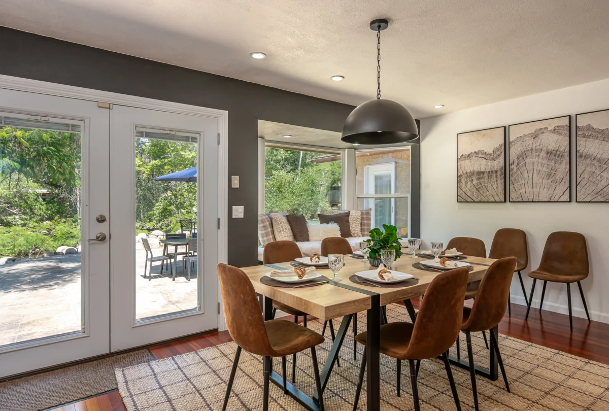 Dining room with leather chairs and French doors to the garden