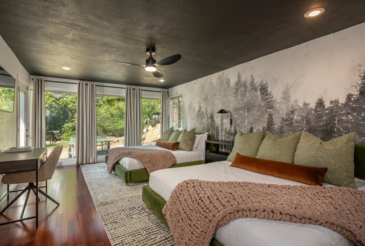 Bedroom with a forest mural and sage green bedding