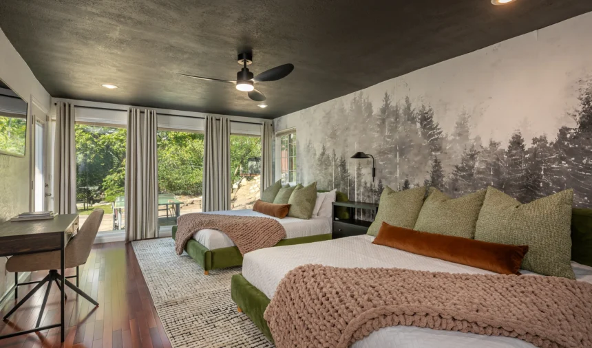 Bedroom with a forest mural and sage green bedding