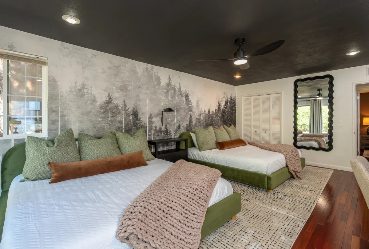 Second bedroom with a forest mural and a dark ceiling