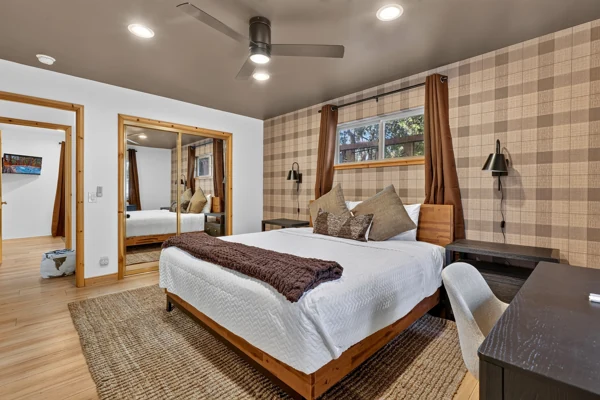 Bedroom with a timber headboard and plaid wallpaper