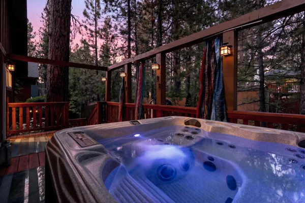 Hot tub lit on the deck at dusk
