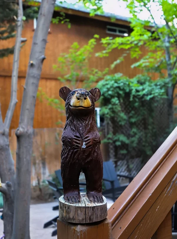 Carved wooden bear beside the deck railing
