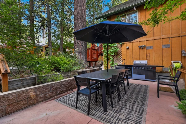 Outdoor dining table under a parasol on the patio