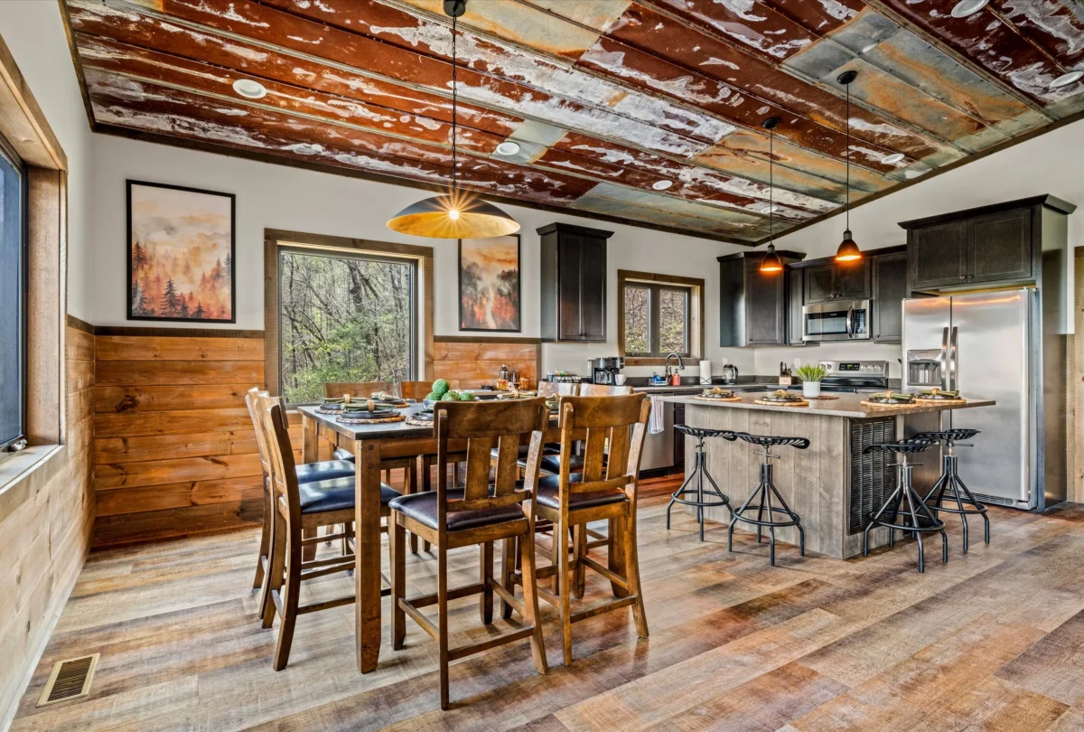 Kitchen and dining room under a reclaimed tin ceiling